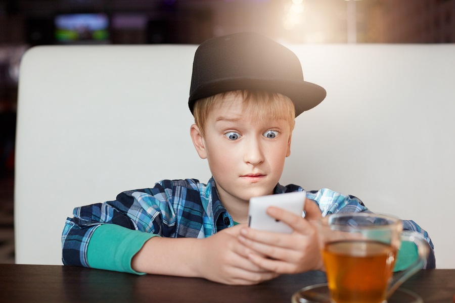young-boy-looking-at-cell-phone